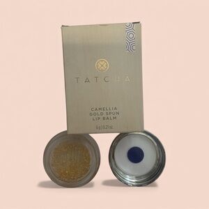 Tatcha Gold Lip Balm with tan accent. This brand is super expensive and popular